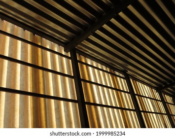 Abstract Photo Of Corrugated Metal Roof And Paper Sunshades Over Burglar Bars