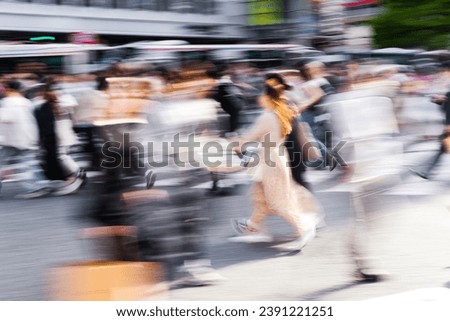 abstract photo of a crowd of people crossing a street in the big city