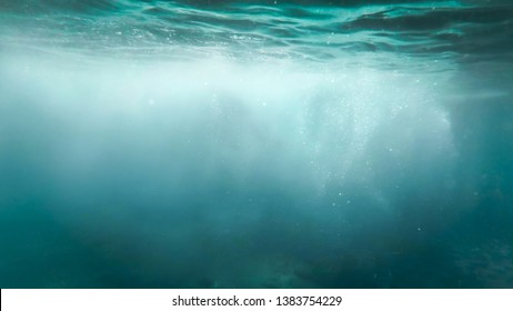 Abstract photo of lots of bubbles floating in clear turqouise sesa water
