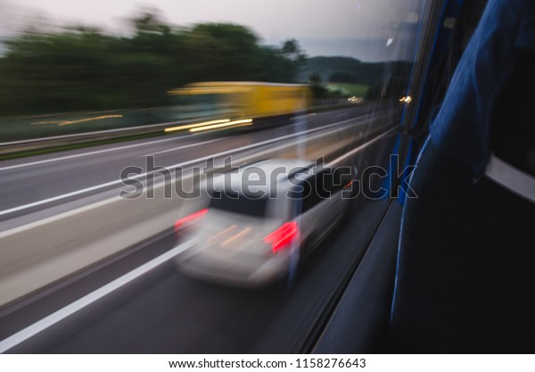 Abstract photo of a moving vehicles on a\
highway. Long\
exposure.