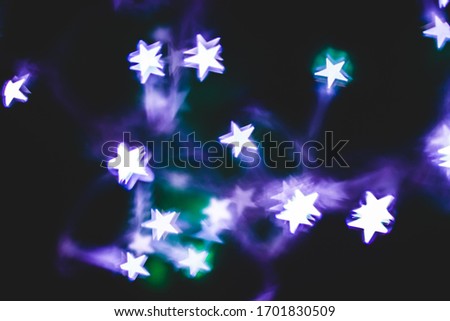 Abstract Photography with Star Shaped Lights with Purple and Green Colors on the Background