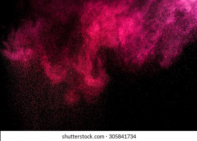 Abstract Pink Powder Explosion On Black Background. 