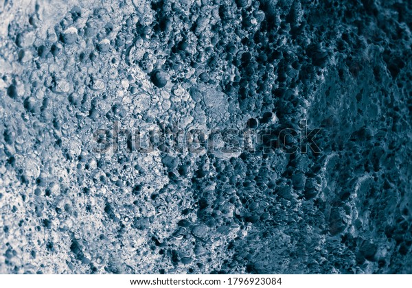 Abstract planet or meteorite\
surface with uneven relief. Asteroid or moon background\
imitation.