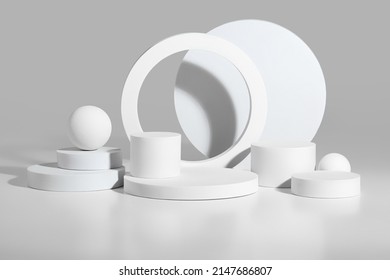 Abstract podium mockup of white cylinders and spheres on gray background
