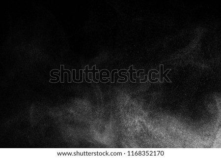 Abstract powder explosion on black background.