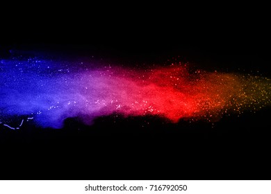 abstract powder splatted background. powder explosion on black background. Colored cloud. Colorful dust explode. Paint Holi.
