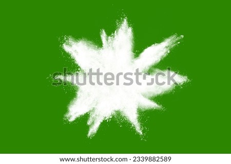 abstract powder splatted background. While powder explosion on green background. Colored cloud. Colorful dust explode. Paint Holi.