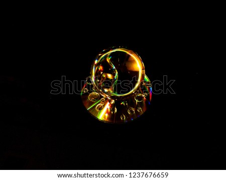 An abstract prism effect using standard white light on a relfective disc.