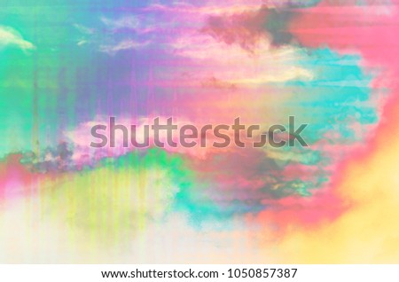 An abstract psychedelic rainbow colored cloudy sky.