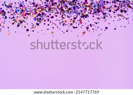 Abstract purple background with multicoloured confetti for your projects. Pink backdrop with copy space. Template. Selective focus