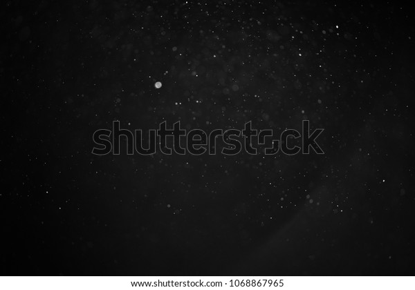 abstract real dust floating over black background\
for overlay