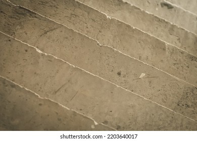 Abstract real photo background. Diagonal lines. View from above concrete stairs like ceramic stoneware tiles wall, pattern with irregular veins material texture decor design. Light brown beige khaki