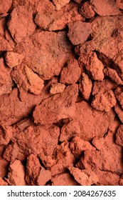 abstract of red clay soil, copper oxide contained rock in deep red color tone, closeup background, texture, taken from above