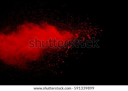 abstract red powder explosion on  black background.abstract red powder splatted on black background. Freeze motion of red powder exploding.