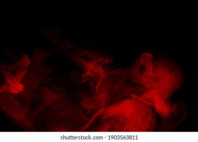 Abstract Red Smoke Moves On Black Background. Beautiful Swirling Smoke.