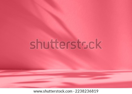 Abstract red studio background for product presentation. Empty room with shadows of window and flowers and palm leaves . room with copy space. Trendy Color of the Year 2023 viva magenta