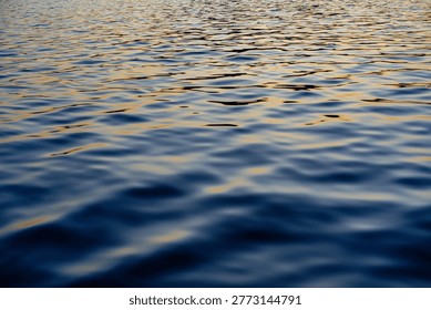 Abstract reflections on the water's surface, vibrant colors.