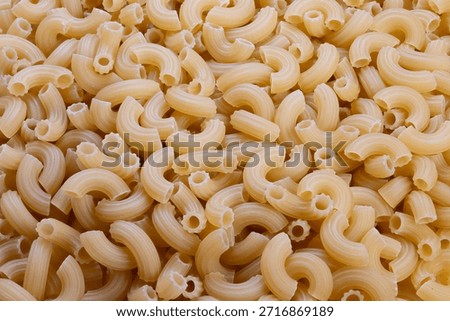 Abstract repeating elbow macaroni pattern creating rhythmic shapes and curves, soft shadows accentuating geometry, versatile backdrop for design and editorial use