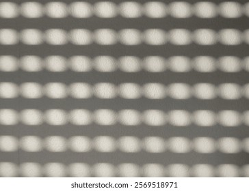 Abstract representation of light and shadow patterns forming a grid on a textured surface, creating a mesmerizing visual effect. ideal for use in creative design projects, backgrounds