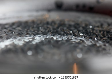 Abstract rippled background texture. Surface of water frozen in time, hi contrast lighting exposes the fascinating patterns created by soundwaves traveling directly through it. 