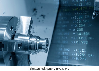 The abstract scene of CNC lathe machine. The turning machine cutting the metal shaft parts with g-code data background.