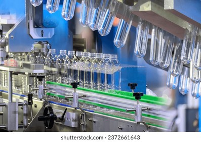 Abstract scene the hi-technology drinking water manufacturing process. The  empty drinking water bottles  on the conveyor belt for filling process.  - Powered by Shutterstock