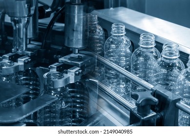 The Abstract Scene Of Plastic Processing Of PET Bottles In The Drinking Water Factory. The Hi-technology Of Plastic Bottle Manufacturing Process.
