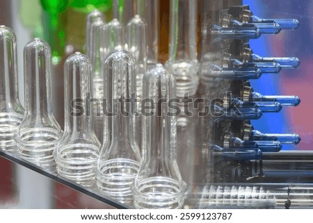Abstract scene the preform shape of PET bottle products and the injection process background. The raw material for plastic bottle manufacturing process.