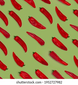 Abstract seamless pattern of fresh red long sweet pointed peppers on color background.