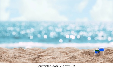 An abstract seascape beach background with a soft blur of bokeh light illuminating the calm sea and sky, while the focus lies on the sandy foreground. - Powered by Shutterstock