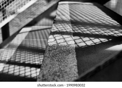 Abstract Shadow Patterns Being Cast By The Stairs Of An External Fire Escape Outside A Building