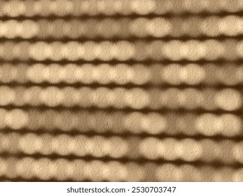 Abstract shadow patterns on a textured surface in warm tones