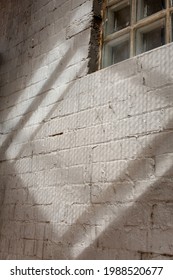 Abstract Shadow Pattwerns Being Cast By The Strairs Of An External Fire Escape Outside A Building