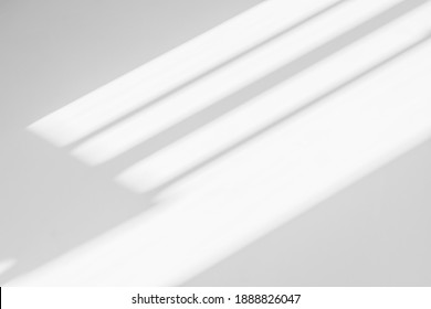 Abstract shadow and striped diagonal light background on white wall  from window,  architecture dark gray and sunshine diagonal geometric effect overlay for backdrop and design