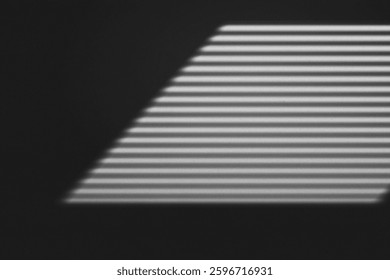 Abstract shadow of window blinds creating parallel lines on a dark wall, evoking a minimalist and moody aesthetic