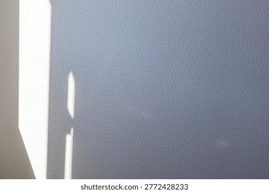Abstract shadow of window light on textured wall minimal background with copy space
