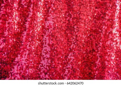 Abstract shiny background with red sparkles. Texture of beautiful fashion fabrics with sparkles. Red color of iridescent tissue   - Shutterstock ID 642062470