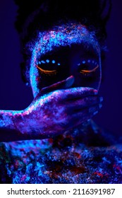 Abstract Shoot Of Beautiful Black Woman Closing Mouth With Hands, With Fluorescent Body Art. Calm Peaceful Lady Keep Silence, Close-up Portrait. Art, Fashion Concept. Body-paint, Isolated