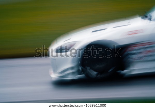 Abstract shot of car on the training race track.\
Extreme long exposure\
image.