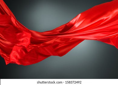 Abstract silk red cloth motion against dark background