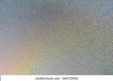 Abstract Silver Paper Texture With Rainbow Color Shiny Glitter Diamond Powder And Light Refraction On Surface For Background And Wallpaper, Defocus