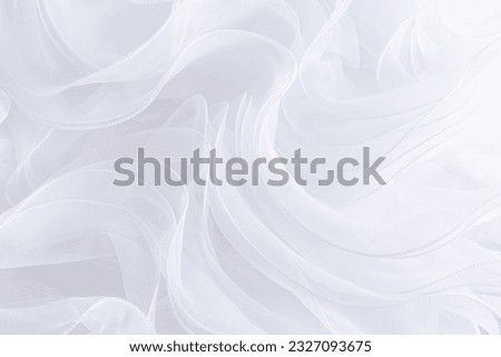 Abstract snow-white background of silk ruffles of white fabric. Delicate background. The concept of a wedding or wedding decor