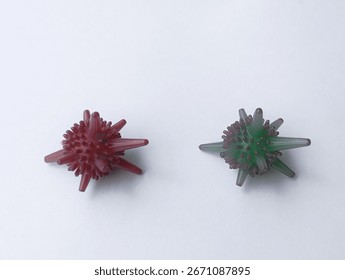 Abstract of spiky objects, small spiky ball. One red and green.