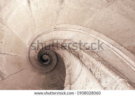 Abstract spiral shape architecture background. Shaped bottom stone staircase spiral design, paler hues. Monochrome cream. Elegant antigue tones. neutral colors. Divine Golden Ratio aesthetic concept