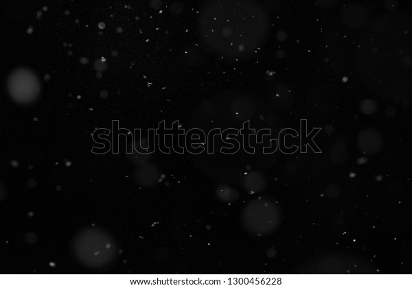 Abstract splashes of Rain and Snow\
Overlay Freeze motion of white particles on black\
background