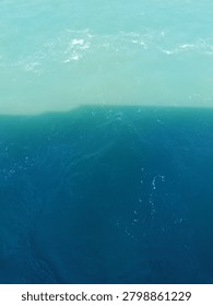 Abstract split tone of turquoise and dark blue sea water surface background