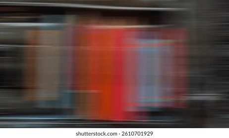 Abstract streaking motion blur over red books creates a trail suggesting fast movement in a literature theme.
