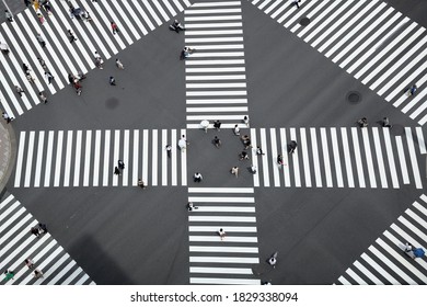 Abstract Street Photo Of Tokyo, Ginza Traffic And People Lifestyle During COVID-19. In The Image Office And Working People Is Crossing The Intersection With Some Holding Umbrella For Sunlight. 