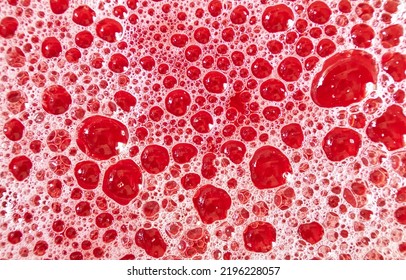 Abstract structure of red foamed surface of liquid. Low-depth background image.
