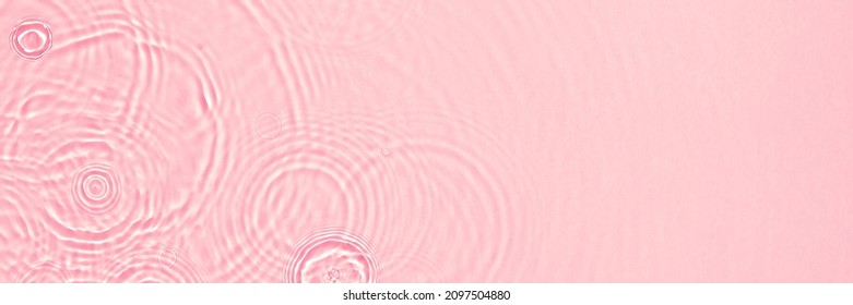 Abstract summer banner background Transparent pink clear water surface texture with ripples, splashes and bubbles. Water waves in sunlight with copy space Cosmetics moisturizer micellar toner emulsion - Shutterstock ID 2097504880